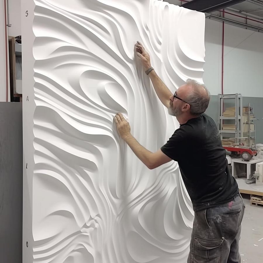 Applying adhesive to the back of a 3D wall panel